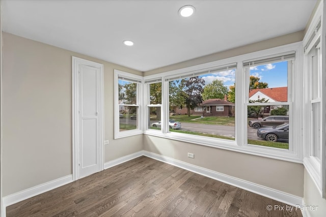 unfurnished room with ceiling fan and dark hardwood / wood-style flooring