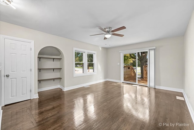 unfurnished bedroom featuring dark hardwood / wood-style floors, a closet, and ceiling fan