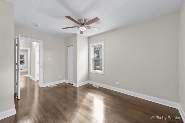 unfurnished bedroom featuring a closet, dark hardwood / wood-style floors, and ceiling fan