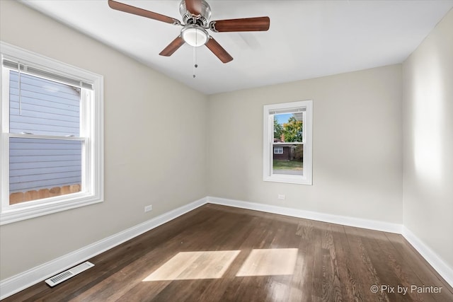 spare room featuring ceiling fan and dark hardwood / wood-style floors