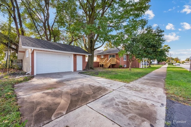 ranch-style home featuring a front lawn and a garage