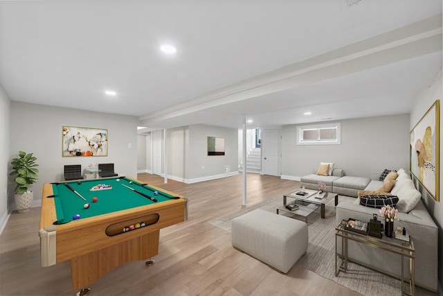 basement with light hardwood / wood-style floors and a healthy amount of sunlight