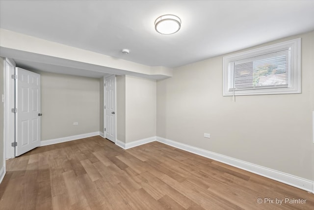 basement with light hardwood / wood-style floors