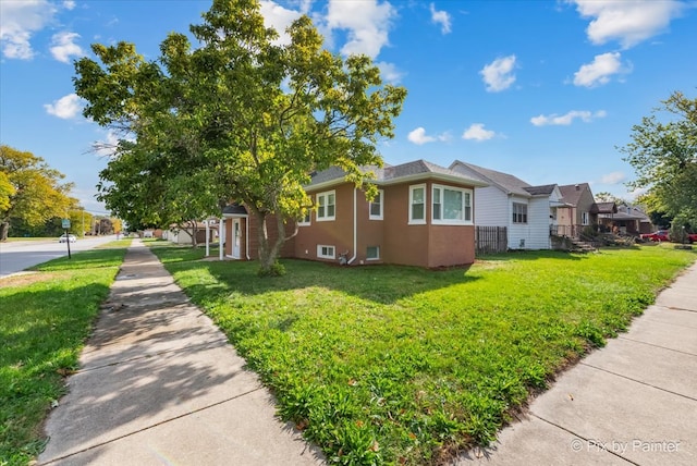 view of front of property with a front yard and a garage