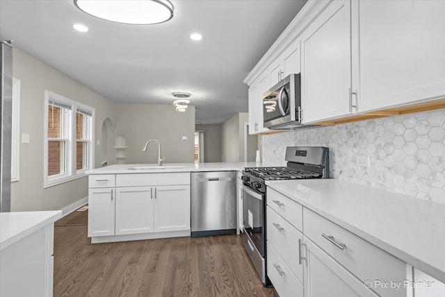 kitchen with stainless steel fridge with ice dispenser, a wealth of natural light, and white cabinets