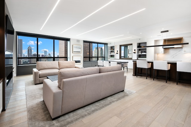 living room featuring light hardwood / wood-style flooring and floor to ceiling windows