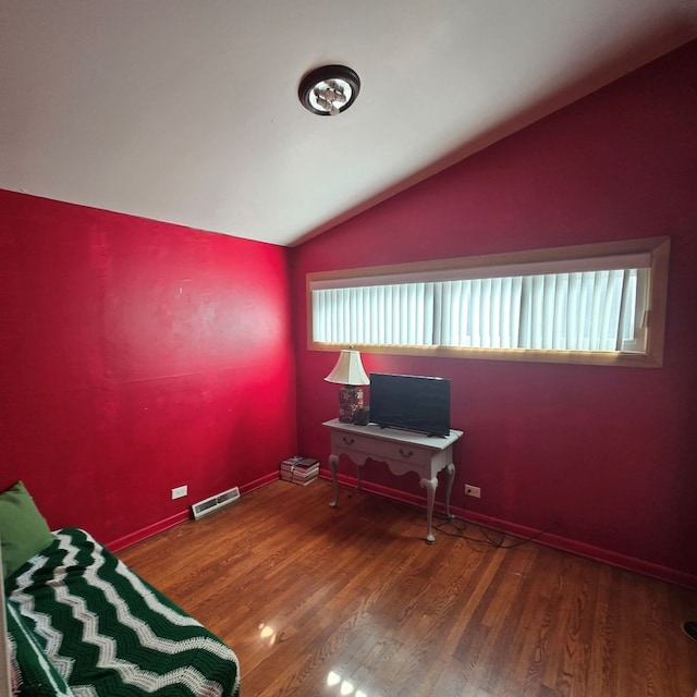 interior space with lofted ceiling and dark hardwood / wood-style flooring