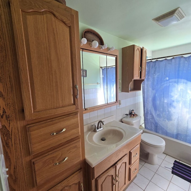 full bathroom with tile patterned floors, toilet, shower / bath combination with curtain, backsplash, and vanity