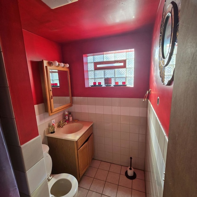 bathroom featuring tile walls, vanity, toilet, and tile patterned flooring