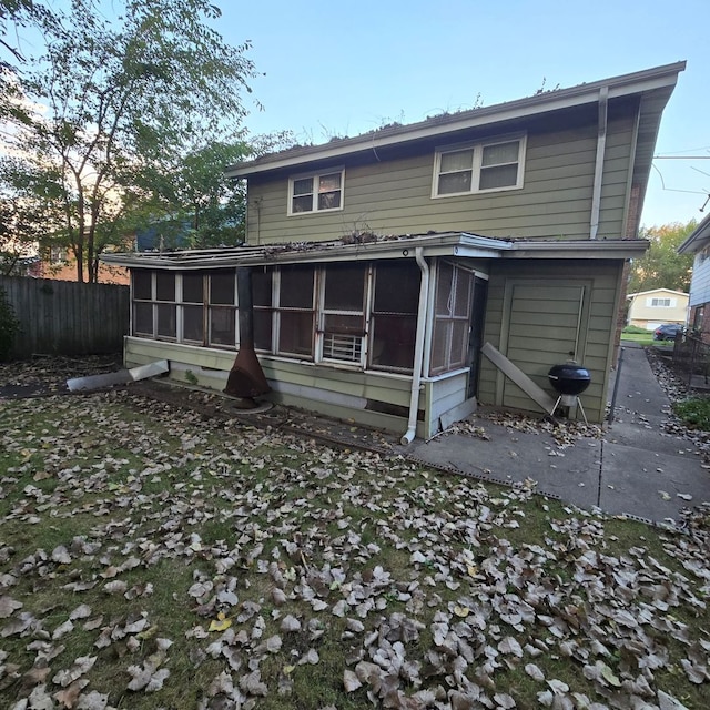 back of property with a sunroom