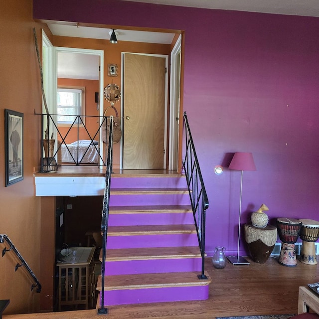 staircase with hardwood / wood-style flooring