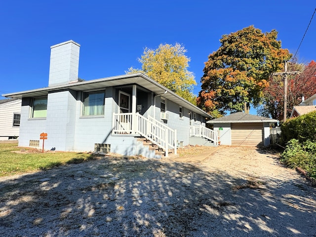 view of front facade with a garage and an outbuilding