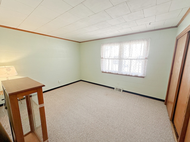 carpeted spare room with ornamental molding