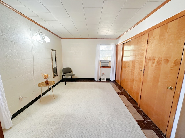 unfurnished room with crown molding, cooling unit, and dark colored carpet