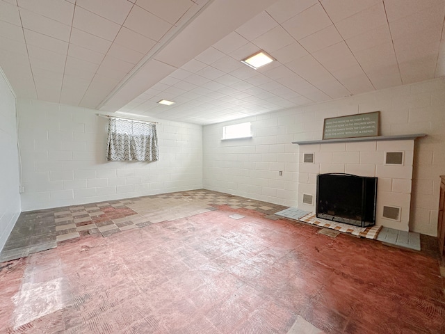 basement with a tiled fireplace