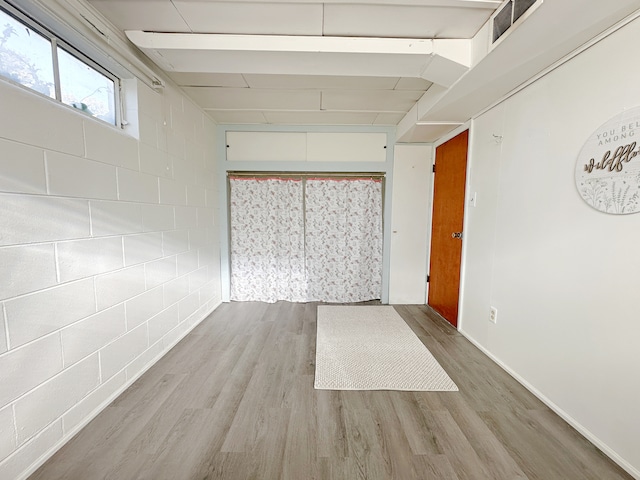 unfurnished room with light wood-type flooring