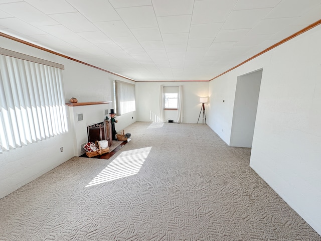 spare room with light carpet and crown molding