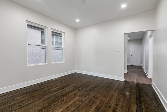 spare room with dark hardwood / wood-style floors