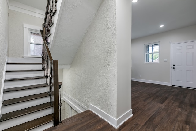 stairs featuring hardwood / wood-style floors