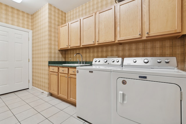 washroom featuring independent washer and dryer, cabinets, sink, and light tile patterned floors