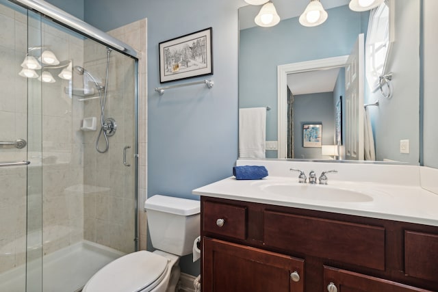 bathroom with vanity, toilet, and walk in shower