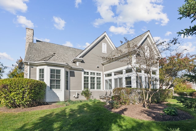 rear view of house with a yard