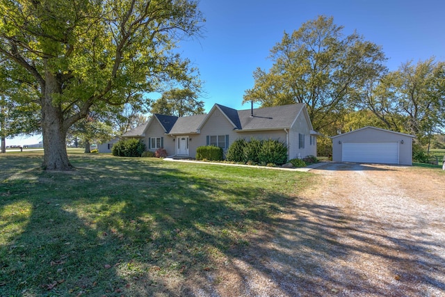 ranch-style home featuring a front yard, an outdoor structure, and a garage