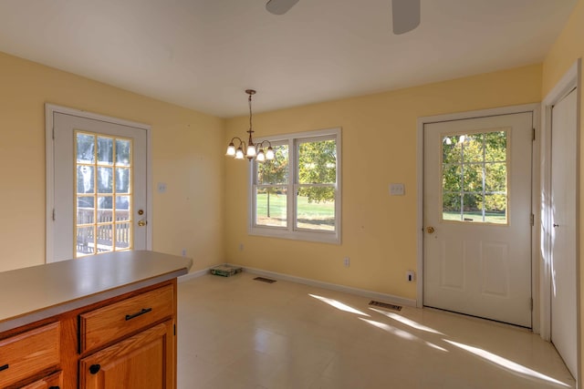 unfurnished dining area featuring an inviting chandelier and plenty of natural light