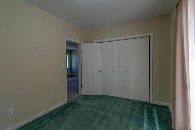 unfurnished bedroom with carpet and a closet