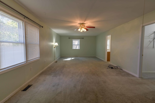 empty room with light colored carpet and ceiling fan