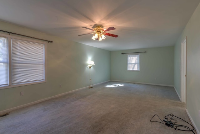 spare room featuring ceiling fan and light colored carpet