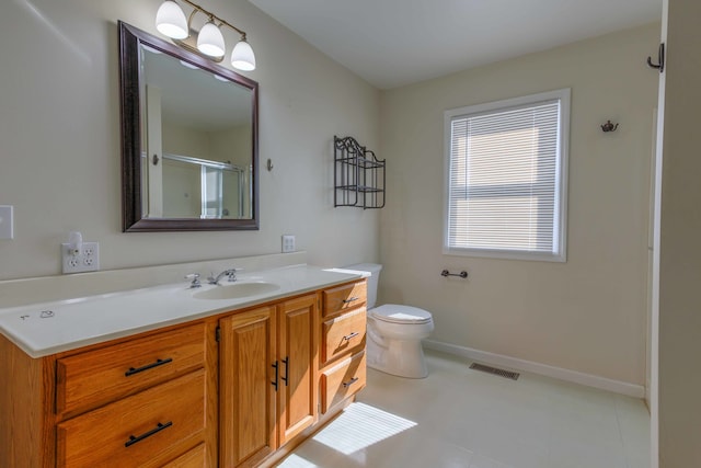 bathroom featuring vanity, tile patterned flooring, toilet, and an enclosed shower