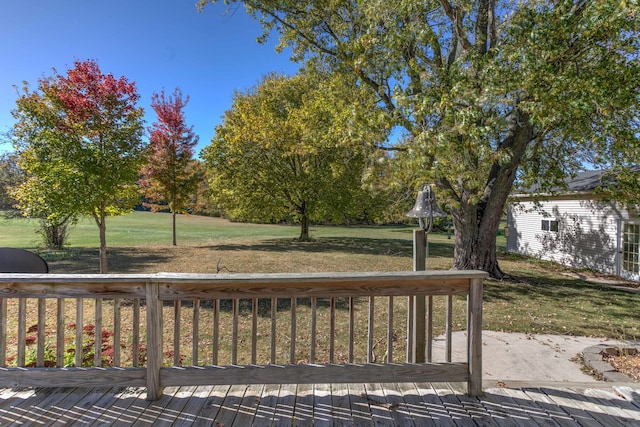 wooden terrace featuring a yard