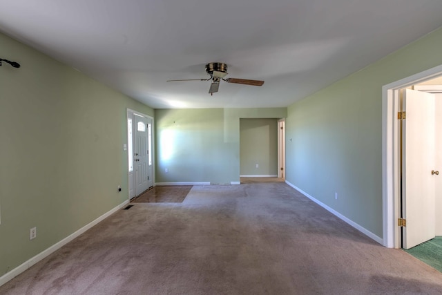 carpeted spare room featuring ceiling fan