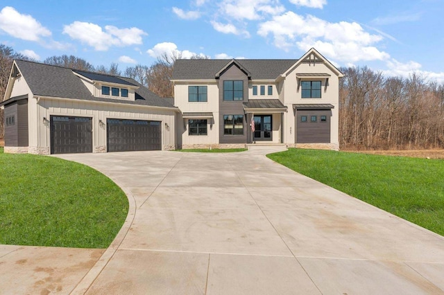 view of front of property featuring a garage and a front lawn