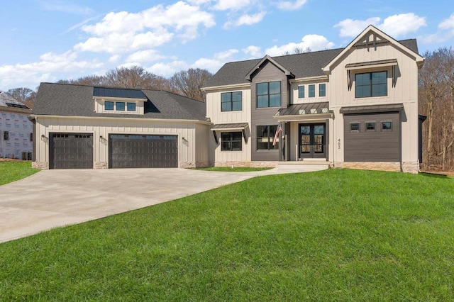 view of front of home with a front lawn and a garage