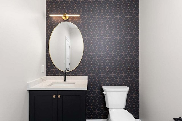 bathroom with tile walls, vanity, and toilet