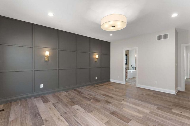 unfurnished room with light hardwood / wood-style flooring