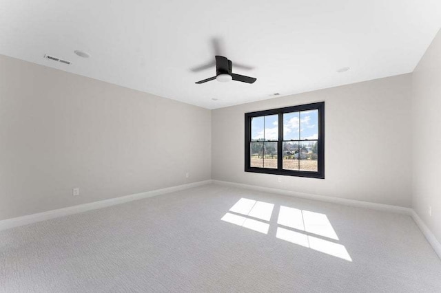 unfurnished room with ceiling fan and light colored carpet