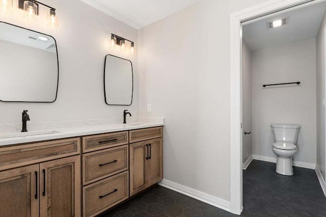 bathroom with tile patterned floors, vanity, and toilet