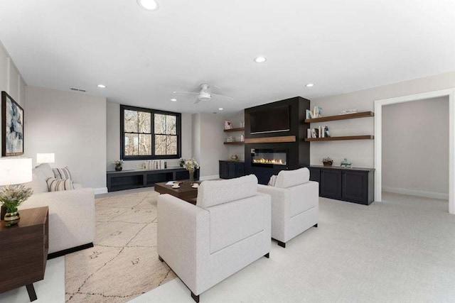 carpeted living room featuring ceiling fan