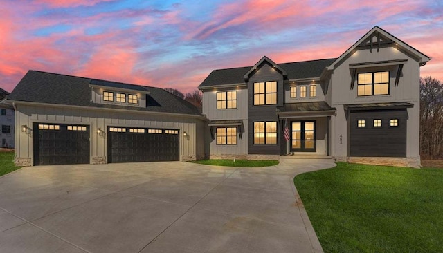 modern farmhouse style home featuring a lawn