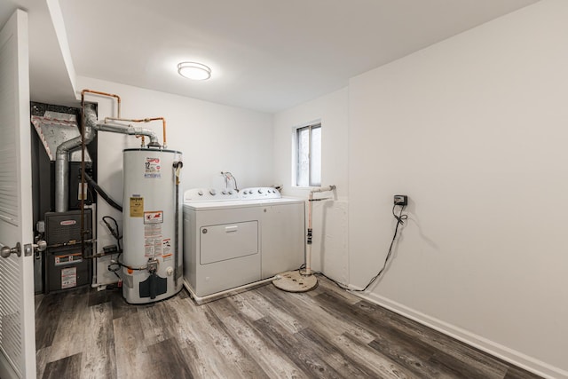 washroom with washer and clothes dryer, gas water heater, and wood-type flooring