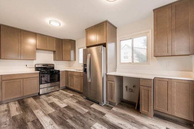 kitchen with stainless steel appliances and dark hardwood / wood-style floors