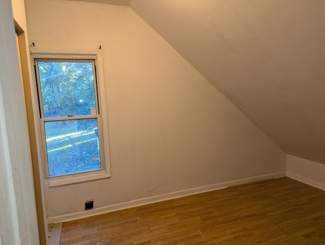 bonus room featuring hardwood / wood-style floors and lofted ceiling