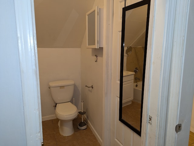 bathroom with toilet and tile patterned floors