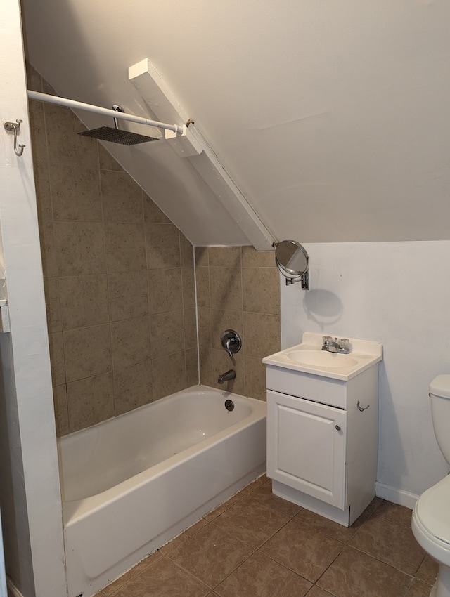 full bathroom featuring vanity, tile patterned flooring, toilet, and tiled shower / bath combo