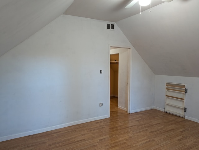 bonus room featuring light hardwood / wood-style floors, ceiling fan, and lofted ceiling