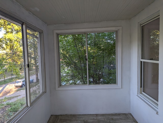 unfurnished sunroom with wooden ceiling and plenty of natural light