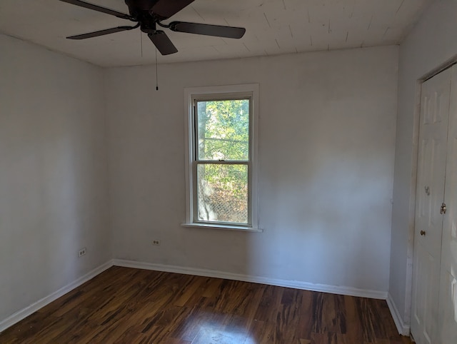 empty room with dark wood-type flooring and ceiling fan